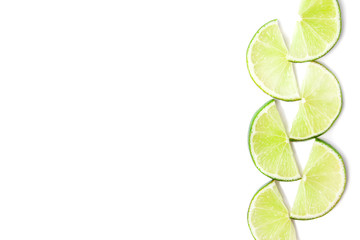 Slices of Juicy green lime at the right side of image isolated on white background. Healthy food concept with copy space