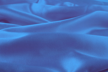 Smooth elegant blue silk or satin texture can use as abstract background, fabric