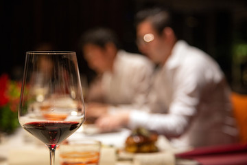 red wine glass on dinner table with friendship