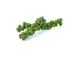 green peppercorns on white background