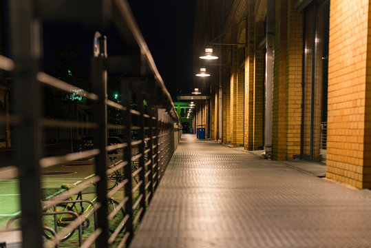Illuminated walkway with railing, Walkway made of stall plates, Walkway at night