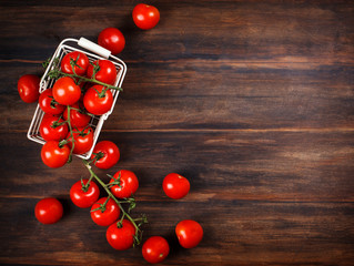 Fresh tomatoes on wooden background