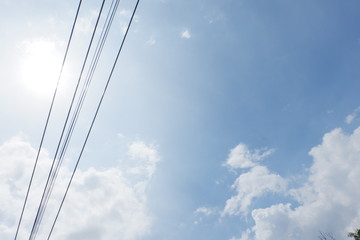 Fototapeta premium Bright skies with electric wires crossing