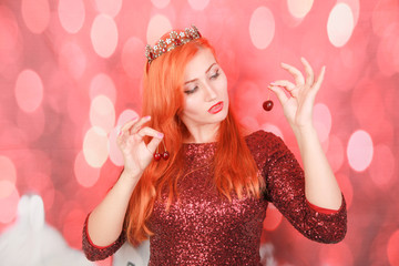 Healthy eating vegetarian concept of woman holding fresh berries cherry wearing christmas dress