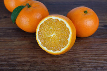 Close-up of cut oranges laid on a wooden table