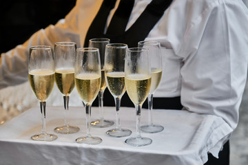 Midsection Of Waiter Serving Prosecco Wine In Glasses During Wedding Ceremony