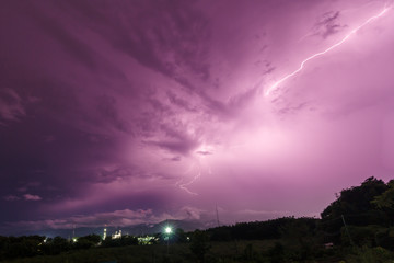 Storm and bright lightning strike at dusk at night