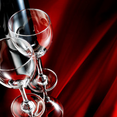 Wineglass and bottle on mirror table