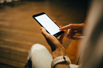 Close-up young woman using smart phone