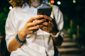 Close-up of young woman's hands holding smart phone