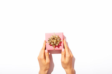 Woman's hands holding small pink gift box