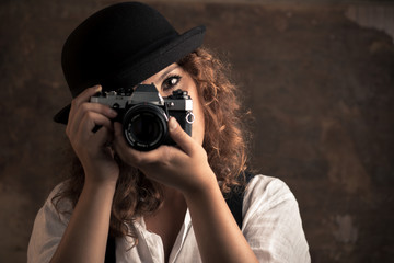 Woman Photographer with Bowler and Suspenders Holding a Camera