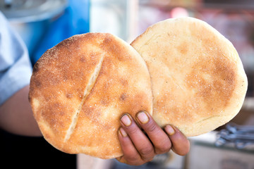 Guy holding in hand Traditional Moroccan flatbread