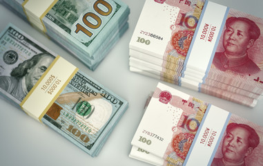 Stacks of chinese 100 Yuan bills and 100 Dollar bills.