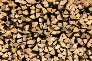 A pile of firewood lit with bright sunlight
