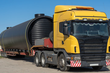 Russia, Omsk, September 4, 2018. Oversized heavy transportations on truck. Long industrial cargo shipped on the trawl.