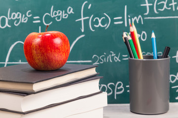 The desk in front of the blackboard