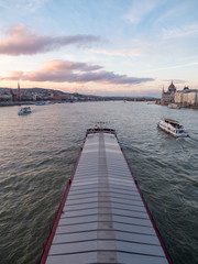 Budapest, Hungary - Mar 9th 2019: Transportation ship in Danube river, Budapest Hungary.The Danube is Europe's second longest river, after the Volga. It is located in Central and Eastern Europe.