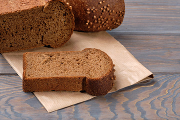 loaf of dark bread partly cut in slices