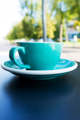 A cup of coffee on the table. A fresh morning in a street cafe.  