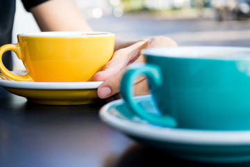 A cup of coffee on the table. A fresh morning in a street cafe.  