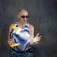 A man with a luminous table lamp.