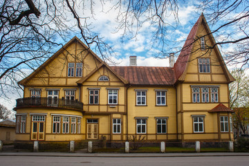 Large old wooden yellow building in historical center of Parnu, Estonia.