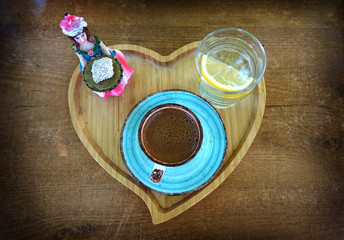 Coffee served with candy and lemonade on wooden tray