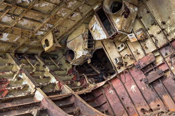 Internal parts of decommissioned marine ship that was cut and left on the shore.