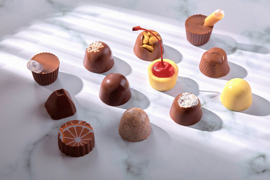 view of various chocolate pralines isolated on stone background - Image