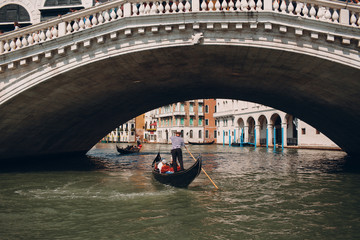 Fototapeta na wymiar Gondolier at the Rialto Bridge, Venice, Italy