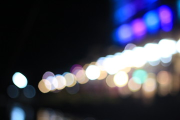 Night twilight blurred bokeh floating market water front, abstract background