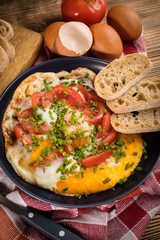 Homemade breakfast fried egg with tomato.