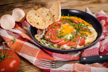 Homemade breakfast fried egg with tomato.