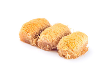 Three greek pastry Kataifi with shredded filo dough stuffed with almond nuts, in honey syrup, isolated on  white