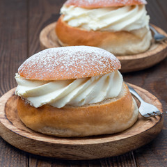 Traditional swedish dessert Semla, also called Shrove bun, with almond paste and whipped cream filling, square format
