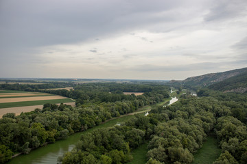 Fototapeta na wymiar Beautiful natural scenery of river in Slovakia, with a green forest and clouds