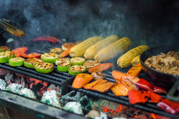 Vegetarian barbeque - corn, zucchini, carrots on the barbeque