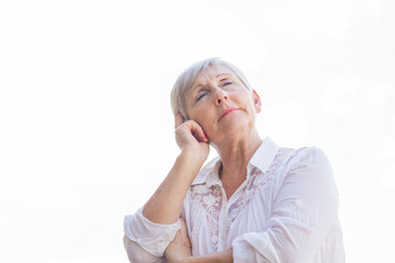 portrait of senior woman with headache isolated on white