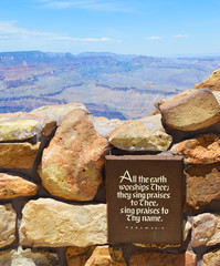 "All the earth worships Thee; they sing praises to Thee, sing praises to Thy name." Psalm 66:4. Plaque in the foreground in focus with the Grand Canyon landscape in the background