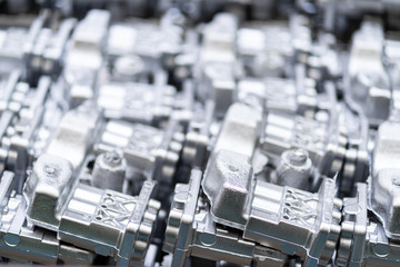 Fototapeta na wymiar Pile of aluminum automotive parts, casting process in the automotive factory