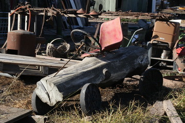 Fototapeta na wymiar abandoned child wood car 