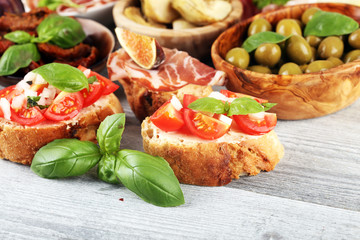 Italian antipasti wine snacks set. Cheese variety, Mediterranean olives, Prosciutto di Parma, tomatoes, artichokes