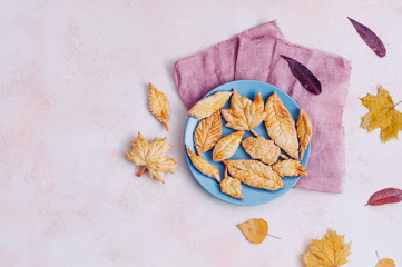 Autumn leaves shape cookies on the plate with copy space