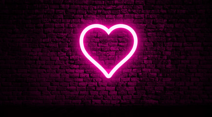 Pink neon heart on brick wall background