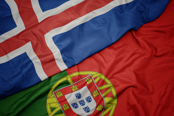 waving colorful flag of portugal and national flag of iceland.