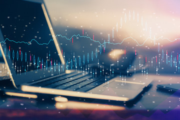 Double exposure of graph and financial info and work space with computer background. Concept of...