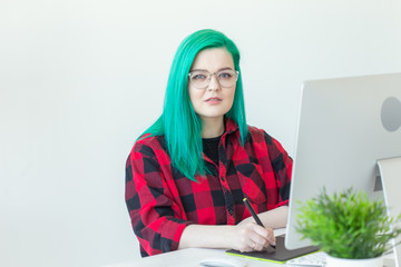 Graphic designer, animator and illustrator concept - young woman with green hair working at the...