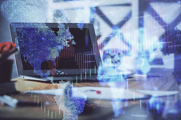 Financial market graph hologram and personal computer on background. Double exposure. Concept of forex.