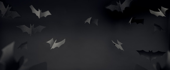 Photo of gray paper bats on blank black background .